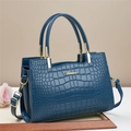 Deep blue tote bag with crocodile texture and gold hardware on a minimalist background - Dark Blue