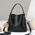 Minimalist black PU leather bucket bag with golden eyelets and brown cloud charm decoration - Black
