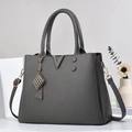 Dark grey pebble leather handbag with V-shaped metal hardware and adjustable strap - Gray
