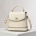 Cream-colored bucket bag with lychee texture and gold clasp, variant showing crossbody strap - Off-white