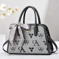 Detail of grey crossbody bag with floral prints and silk scarf tied to the handle - Gray