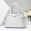 Detail of white crocodile texture tote bag with golden hardware and floral decor - White