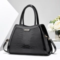 Chic black crocodile embossed leather handbag with shiny patent trim and gold hardware - Black
