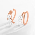 Close-up of rose gold ear bone clips with three white pearls on white marble background - Rose Gold Three Pearls Style (EP5617C)