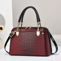 Deep red lizard-patterned Boston bag with black glossy straps and golden metal hardware - Wine Red