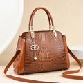 Elegant brown crocodile pattern handbag with pearl pendant and adjustable strap - Earthy Yellow