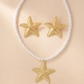 Vista dettagliata del set di gioielli a stella marina dorata con perle e orecchini - Oro