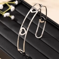 Minimalist silver hollow heart open choker with a polished metallic finish on a display - Silver