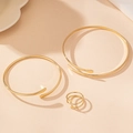 Detailed close-up of gold-plated bangle set and triple-layered spiral open ring - Gold