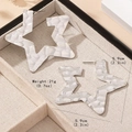 Large hammered silver star stud earrings with 5.9cm diameter in a beige jewelry box - Silver