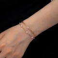 Double-layered gold chain bracelet with paperclip links and elegant white pearls for women - Gold