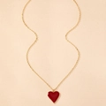 Detailed close-up of a gold O-chain necklace featuring a polished red enamel heart pendant - Burgundy