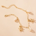 Detail of gold starfish and white seashell charms on a minimalist summer anklet chain - Gold