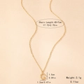 Macro detail of gold letter G necklace with bamboo texture showing dimensions 45+7cm - Letter G