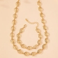Set di gioielli dorati lucidi con collana e bracciale a spirale e chiusura a moschettone - Oro