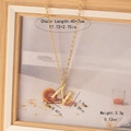 Detail of gold letter N necklace with bamboo texture showing length and weight specs - Letter N
