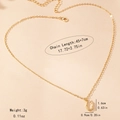 Detail view of golden bamboo style letter necklace with size measurements 45 plus 7cm - Letter U