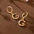 Detail view of bamboo texture gold letter G hoop earrings with dimensions 2.8cm and 2.4g weight - Letter G Style