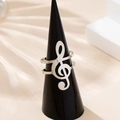 Silver music note ring featuring a treble clef design with a layered band style - Silver