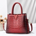 Glossy red crocodile texture handbag with gold V buckle and adjustable shoulder strap - Earthy Yellow