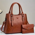 Close-up of brown leather handbag set with metal rivets and detachable shoulder strap - Khaki/Earth Yellow
