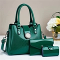 Detail of dark green embossed patent leather handbag set with silver hardware - Green