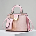 Detailed view of pink lizard embossed tote bag with glossy finish and gold metal hardware - Pink