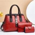 Three-piece red faux leather handbag set with tote, wallet and pouch on beige background - Red