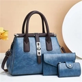 Close-up of three-piece vintage blue and brown leather handbags with silver hardware - Blue