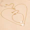 Elegant gold jewelry set with heart-shaped shell pendants including necklace and bracelet - Gold Heart Shell Set
