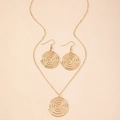 Detail of elegant gold swirl jewelry set featuring spiral pendant necklace and matching earrings - Gold Bangle and Ring Set