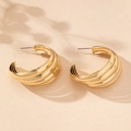 Détail de boucles d'oreilles dorées multicouches en forme de C avec fini métallique - Jaune d'Or