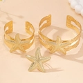 Detail showing hammered texture and starfish charms on golden bracelet and ring set - Golden 3-Piece Set