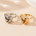 Detail of twisted knot gold and silver rings with textured finish and adjustable open band - Gold and Silver 2-Piece Set