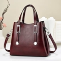Macro detail of wine red leather handbag with vintage texture and silver metal hardware - Burgundy