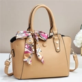 Dettaglio della borsa in pelle a grana con elegante foulard in seta e rivetti dorati - Beige
