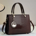 Detail of dark brown lizard texture handbag featuring a golden swan charm and dual handles - Coffee (806-3#)