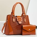 Detail of lizard-pattern faux leather handbag and matching envelope wallet in orange - Khaki/Earth Yellow
