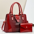 Detail of red lizard texture handbag with matching envelope wallet and dual handles - Red