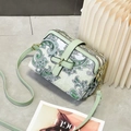 Detail of light green paisley crossbody bag showing three zipper compartments and gold hardware - Retro Paisley Print / Green