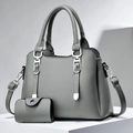 Minimalist grey lychee texture leather tote bag set with matching coin purse on white block - Gray