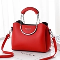 Fashionable red leather crossbody bag with circular metal handle and silver chain strap - Red