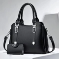 Close-up of black pebbled leather tote bag with matching coin purse and silver hardware - Black