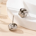 Elegant silver-toned twisted love knot stud earrings with polished and textured finishes - Silver