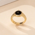 Close-up of vintage gold watch ring featuring a black dial and textured metallic band - Black