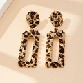 Detail of gold rectangular earrings with leopard print texture and lava metal finish - Leopard Print