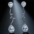 Close-up of silver tassel earrings featuring sparkling pear-cut cubic zirconia stones - Silver Vine Teardrop Dangle