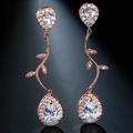 Detail of rose gold tassel earrings featuring pear-cut zircon and crystal vine design - Rose Gold Vine Teardrop Dangle
