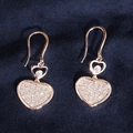 Detail of rose gold heart earrings with white zircon pavé setting on blue velvet - Rose Gold Heart Ear Hooks