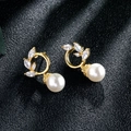 Close-up of gold tassel earrings with zircon marquise leaves and round pearls - Gold Leaf with Pearl Stud Earrings